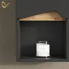 A close-up view of a shelf with a candle in a glass jar. Produktbild-Vorschau