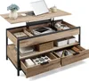 A lift-top coffee table with multiple storage compartments, shown with a laptop, tablet, headphones, and other items. Náhľad obrázku produktu