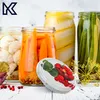 Jars of preserved vegetables and fruits with a lid in the foreground. Podgląd zdjęcia produktu