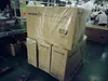 A factory or warehouse setting with boxes of products stacked on pallets. Produktbild-Vorschau