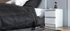 A bedroom scene with a bed and a nightstand. Produktbild-Vorschau
