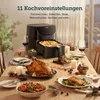 A table set for a meal with an air fryer and various dishes. Produktbild-Vorschau