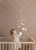 A baby in a crib playing with a mobile. Podgląd zdjęcia produktu