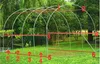 A greenhouse frame structure with red lines and numbers indicating measurements, set up on a grassy lawn with trees in the background. Náhled obrázku produktu