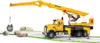 A yellow and white Bruder MACK Granite Liebherr crane truck is shown with a rock being lifted by its crane. Náhľad obrázku produktu