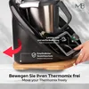 A close-up shot of a kitchen appliance on a wooden board, with a hand interacting with it. Text overlays highlight features. Produktbild-Vorschau