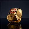 A close-up studio shot of a luxurious golden perfume bottle with red gem accents, set against a dark, reflective background. Voir les images du produit