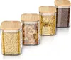 Four glass storage jars with bamboo lids are arranged diagonally on a white background. Produktbild-Vorschau