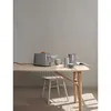 A gray toaster with a slice of bread in it sits on a wooden table, alongside a pitcher and cups. Anteprima dell’immagine prodotto