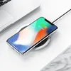 A smartphone is wirelessly charging on a charging pad next to a laptop. Produktbild-Vorschau