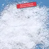 A pile of artificial snow on a light blue background, with a red banner indicating the product's weight and purpose. Produktbild-Vorschau