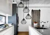 A modern kitchen with a sleek island and pendant lights. Produktbild-Vorschau