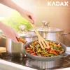 A person is cooking food in a cast iron pan on a stovetop, with pots in the background. Produktbild-Vorschau