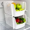 Two white stacking storage bins filled with fruits and vegetables inside a refrigerator. Anteprima dell’immagine prodotto