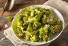 A plate of Romanesco broccoli with shaved cheese on a wooden table. Voir les images du produit