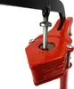 A close-up view of a red bottle capper mechanism with a silver screw and black hook. Anteprima dell’immagine prodotto