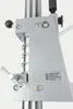 A close-up view of a metal drill stand component with a manufacturer's label. Náhľad obrázku produktu