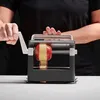 A person is using an apple peeler. Produktbild-Vorschau