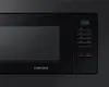 A close-up shot of a black Samsung microwave oven. Podgląd zdjęcia produktu