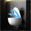 A modern, wall-hung toilet with a blue toilet seat lid open, set against a dark tiled wall and a dark marble floor. Náhľad obrázku produktu