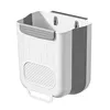 A white and gray collapsible trash can is shown hanging on a wall. Produktbild-Vorschau
