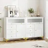 A white storage cabinet with glass doors and gold legs is displayed in a room with blinds casting shadows. Produktbild-Vorschau