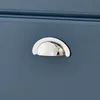 Close-up of a drawer handle on a blue cabinet. Produktbild-Vorschau