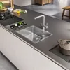 A modern kitchen counter with a sink, faucet, and cooking utensils. Anteprima dell’immagine prodotto