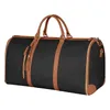 A black duffel bag with brown leather accents, shown against a white background. Produktbild-Vorschau