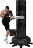 A muscular man is kicking a freestanding punching bag. Produktbild-Vorschau