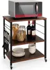 A three-tier kitchen cart with a microwave on top and various kitchen items on the shelves. Voir les images du produit