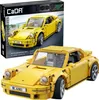 A product box and a built model of a yellow sports car. Voir les images du produit