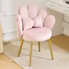 A pink velvet accent chair with gold legs in a room with a dresser in the background. Náhľad obrázku produktu
