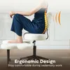 A person is sitting on an ergonomic chair with a lumbar support cushion. Produktbild-Vorschau