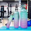 Drei Verlauf türkise und lila Motivations-Wasserflaschen in verschiedenen Größen in einem Fitnessstudio Voir les images du produit