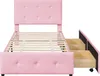 A pink upholstered twin bed frame with a tufted headboard and two pull-out drawers on the side. Náhled obrázku produktu