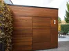 A modern wooden building with a double door and two wall lights. Podgląd zdjęcia produktu