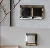 Two electrical outlets are mounted on a textured wall, with a branch from a plant in the foreground. Anteprima dell’immagine prodotto
