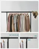 A clothing rack filled with sweaters and shirts, with illustrative diagrams below showing adjustability. Produktbild-Vorschau