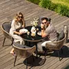 A couple enjoys a meal at a patio table on a wooden deck. Náhled obrázku produktu