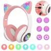 A pair of pink and white cat-ear headphones with RGB lighting on the ears and a paw print on the side. To the right are icons representing features and connectivity. Náhľad obrázku produktu