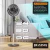 A stand fan is shown in a living room setting with a couch in the background. Text overlays highlight product features. Podgląd zdjęcia produktu