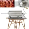A stainless steel sausage stuffer sits on a wooden table. Náhled obrázku produktu