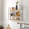 A three-tiered wooden shelf mounted on a white tiled wall, displaying various kitchen items. Náhled obrázku produktu