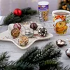 A festive Christmas scene with chocolates, hot chocolate, and pine branches. Anteprima dell’immagine prodotto
