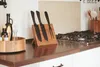 A kitchen counter with a knife block, bottles of oil, and a gas stove. Produktbild-Vorschau