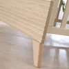A close-up shot of the wooden leg and side panel of a baby crib. Produktbild-Vorschau