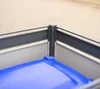 Close-up view of a blue trash can lid inside a gray bin enclosure. Náhled obrázku produktu