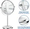 A chrome-plated stand cosmetic mirror with a reflection of a bathroom in the mirror. There are also close-up images highlighting features and text descriptions. Produktbild-Vorschau