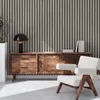 A living room scene with a wooden sideboard, a chair, and a lamp. Náhled obrázku produktu